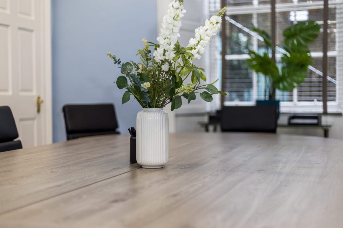 White ceramic vase with fresh flowers on the boardroom table at 28 York Place.