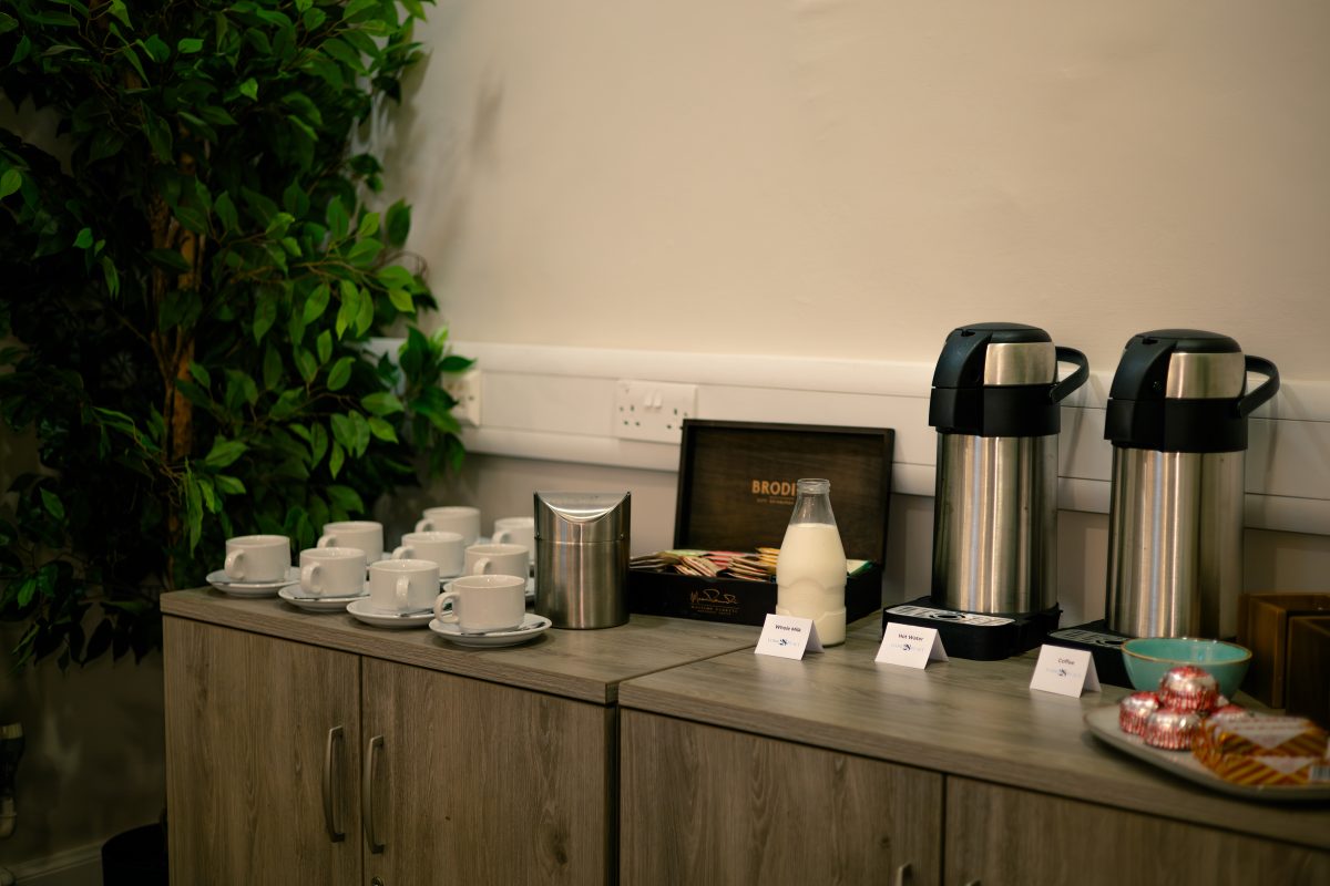 Tea and coffee station with cups, flasks, milk, and biscuits set up for a meeting at 28 York Place.